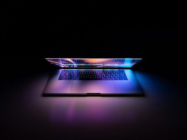 MacBook Pro turned-on on white surface